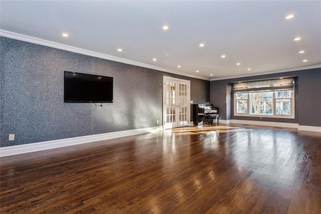 unfurnished living room featuring dark hardwood / wood-style flooring, crown molding, and french doors