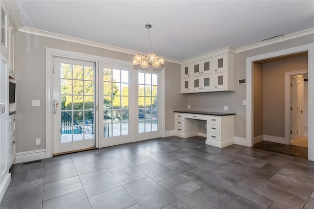 interior space with white cabinetry, wall oven, a notable chandelier, crown molding, and decorative light fixtures