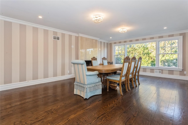 dining area with dark hardwood / wood-style floors and ornamental molding