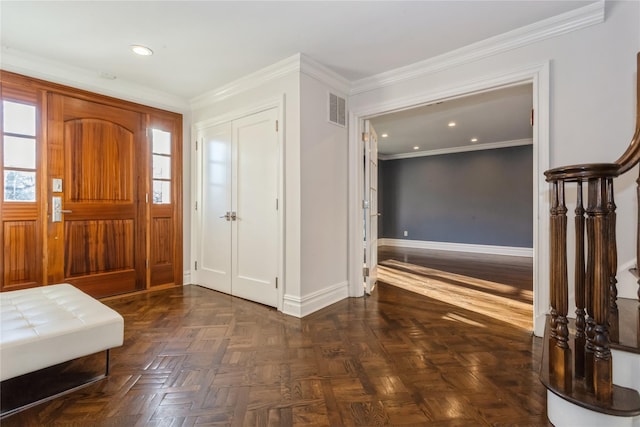 entrance foyer featuring dark parquet floors, plenty of natural light, and ornamental molding