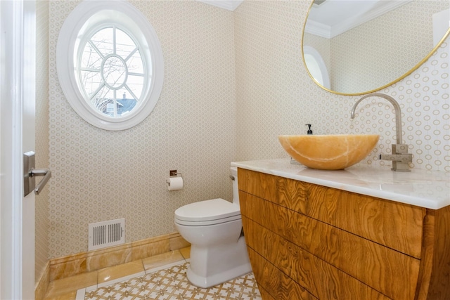 bathroom featuring toilet, vanity, tile patterned floors, and ornamental molding