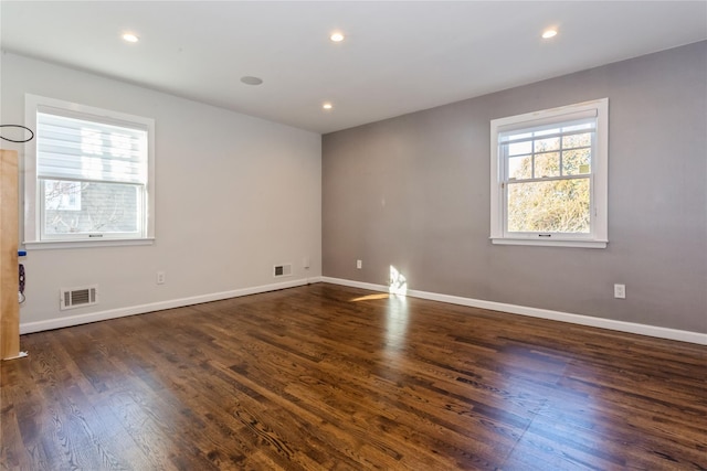 spare room with dark wood-type flooring