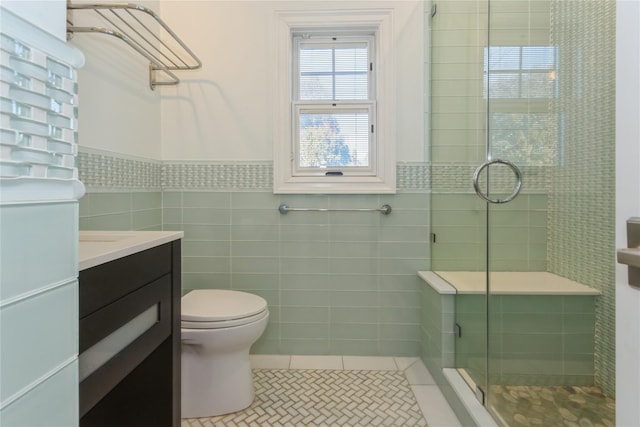 bathroom with vanity, tile patterned flooring, toilet, tile walls, and an enclosed shower