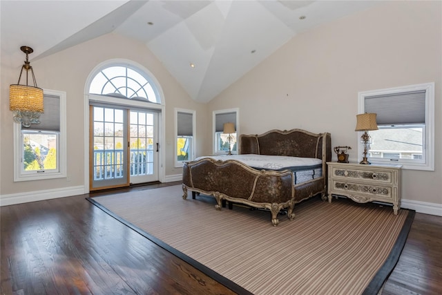 bedroom featuring access to exterior, lofted ceiling, and dark wood-type flooring