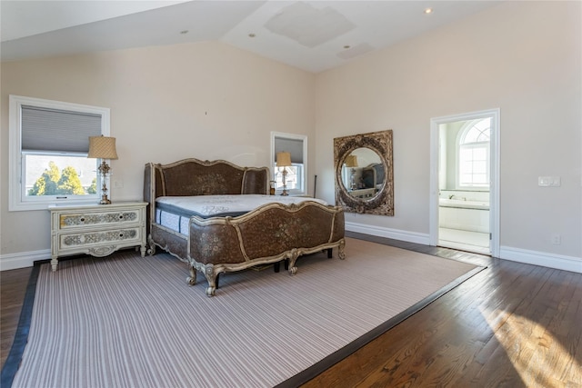 bedroom featuring dark hardwood / wood-style flooring, ensuite bathroom, and lofted ceiling