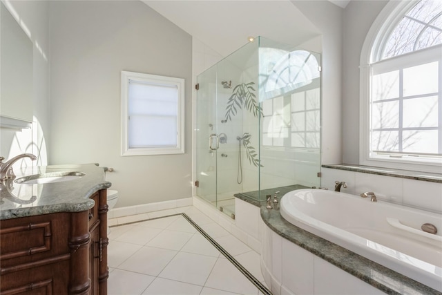 full bathroom featuring vanity, vaulted ceiling, tile patterned flooring, shower with separate bathtub, and toilet