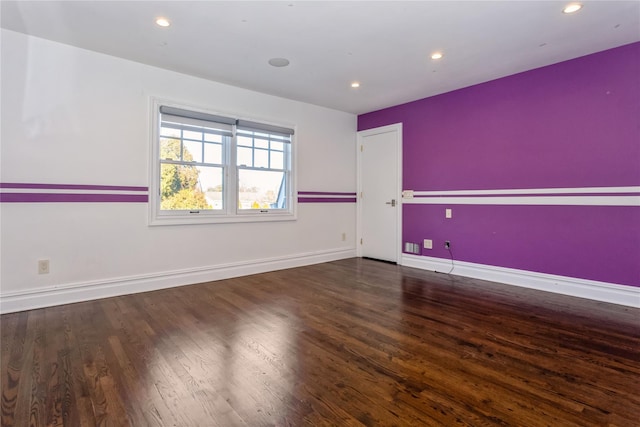 unfurnished room featuring dark hardwood / wood-style flooring