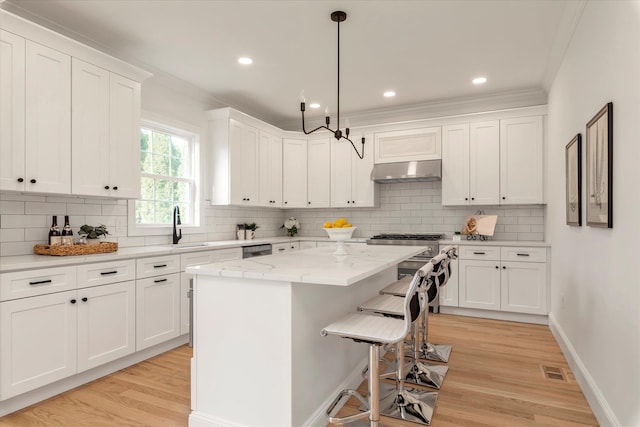 kitchen featuring a center island, white cabinets, and light hardwood / wood-style flooring