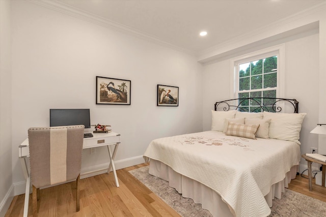 bedroom with light hardwood / wood-style floors and ornamental molding