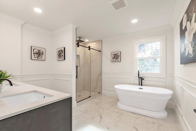 bathroom with plus walk in shower, vanity, and crown molding