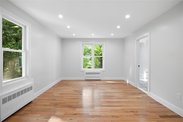 empty room featuring light hardwood / wood-style floors and radiator