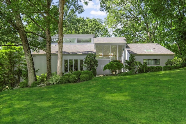 rear view of property with a yard