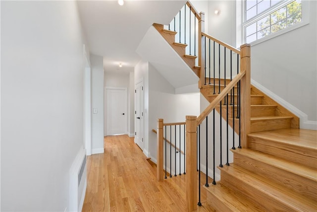 stairs featuring hardwood / wood-style flooring