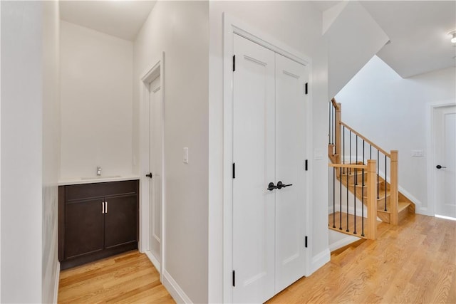 hall featuring light hardwood / wood-style flooring and sink