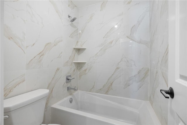 bathroom featuring toilet and tiled shower / bath