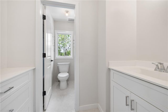 bathroom with tile patterned flooring, vanity, and toilet