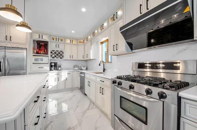 kitchen featuring sink, hanging light fixtures, stainless steel appliances, tasteful backsplash, and white cabinets