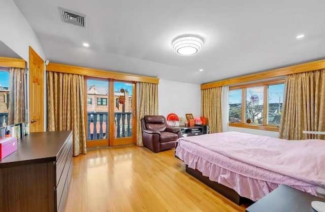 bedroom featuring access to exterior and light hardwood / wood-style flooring