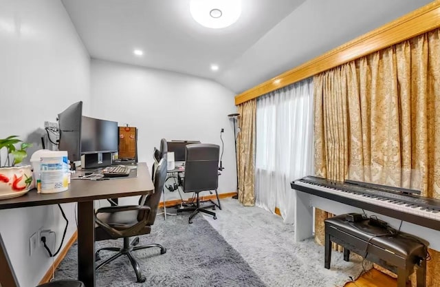 carpeted office with vaulted ceiling