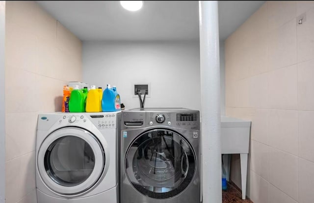 washroom with independent washer and dryer