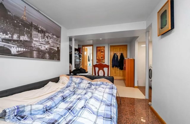 bedroom featuring washer / clothes dryer and a closet