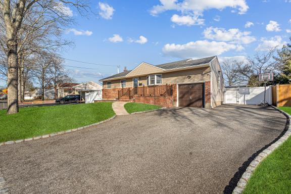 ranch-style home featuring a garage and a front yard