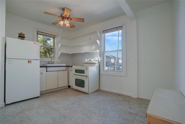 kitchen with ceiling fan, a wealth of natural light, sink, and white appliances