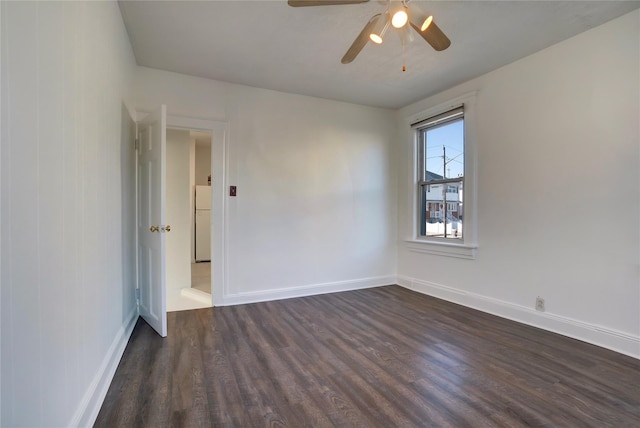 spare room featuring ceiling fan and dark hardwood / wood-style floors