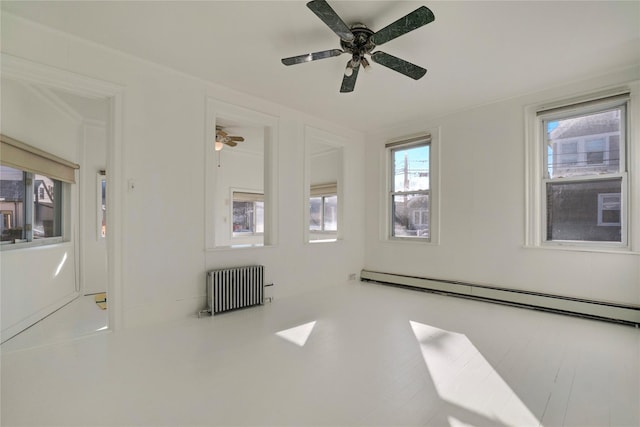 empty room featuring ceiling fan, a baseboard radiator, and radiator heating unit