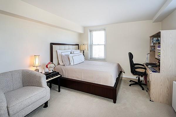 bedroom featuring light colored carpet