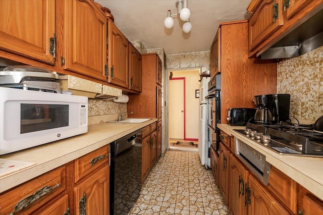 kitchen featuring gas cooktop, premium range hood, tasteful backsplash, sink, and black dishwasher