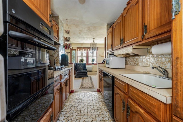 kitchen featuring backsplash, sink, decorative light fixtures, a notable chandelier, and black dishwasher