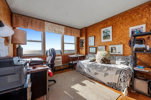 bedroom with a textured ceiling and a water view