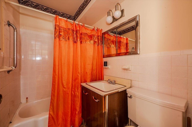 full bathroom with vanity, shower / bath combo, tile walls, and toilet