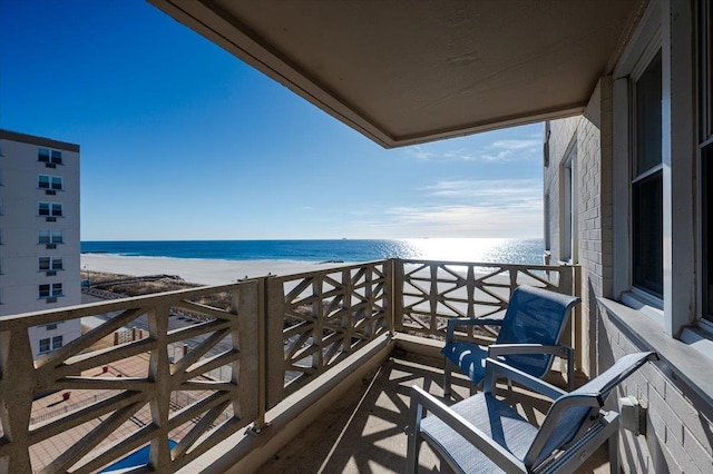 balcony with a view of the beach and a water view