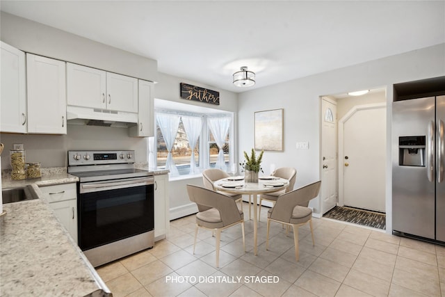 kitchen with white cabinets, light tile patterned floors, and stainless steel appliances