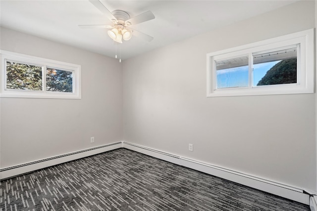 carpeted empty room with a baseboard radiator, a wealth of natural light, and ceiling fan