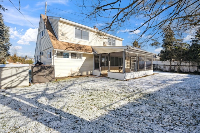 back of house featuring a sunroom