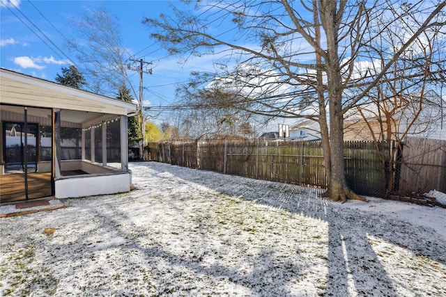 yard covered in snow with a sunroom