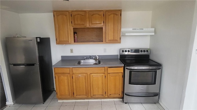 kitchen featuring sink, light tile patterned floors, and stainless steel appliances