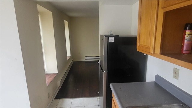 kitchen featuring stainless steel refrigerator and light tile patterned flooring