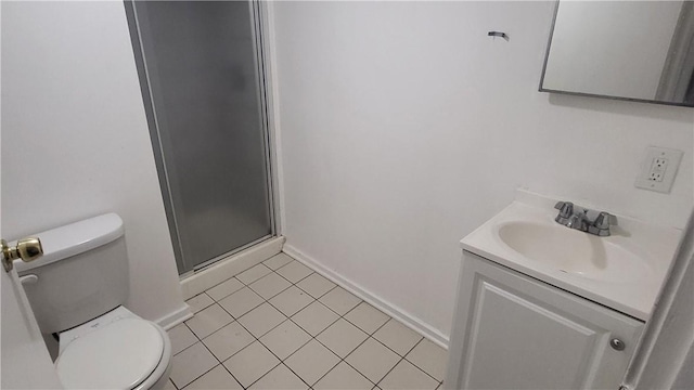 bathroom with tile patterned floors, vanity, toilet, and a shower with door