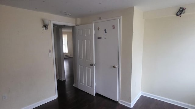 corridor featuring dark hardwood / wood-style floors