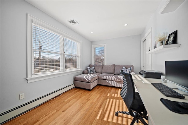 office featuring baseboard heating and light hardwood / wood-style flooring