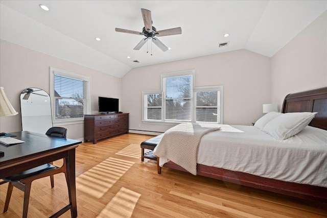 bedroom featuring ceiling fan, light hardwood / wood-style floors, and lofted ceiling