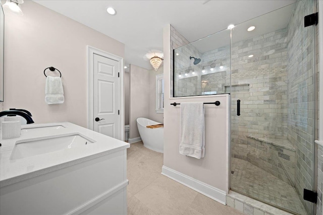 bathroom with tile patterned floors, vanity, and separate shower and tub