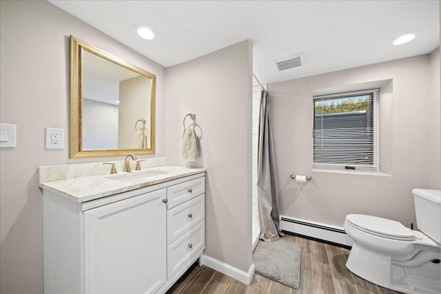 bathroom with vanity, toilet, and a baseboard radiator