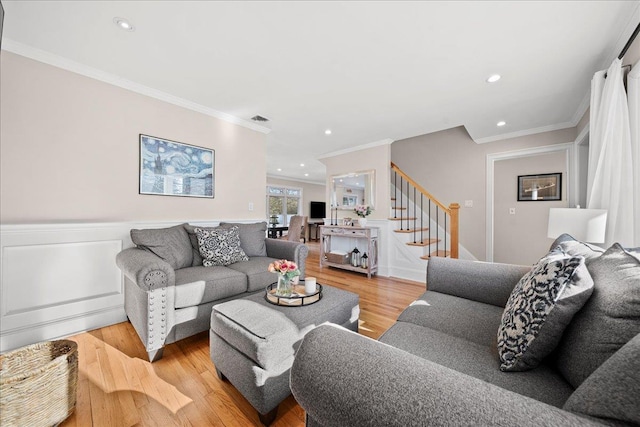 living room featuring light hardwood / wood-style flooring and crown molding