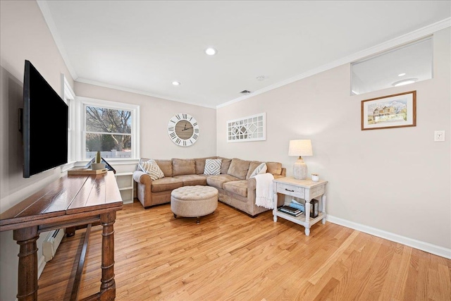 living room with crown molding and light wood-type flooring