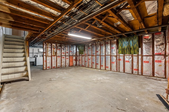 miscellaneous room with washer / dryer and concrete flooring